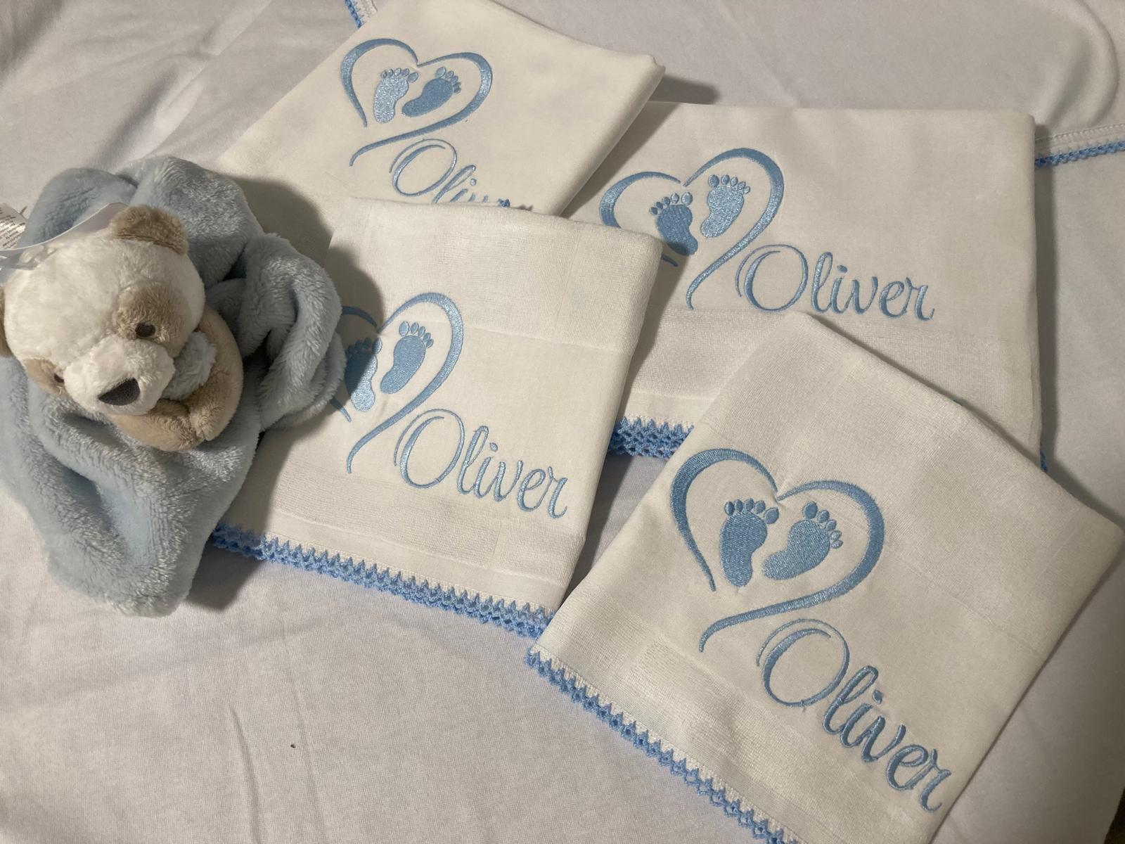 Set of baby cloths embroidered with name Oliver and baby feet
